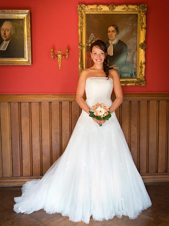 Bride posing in front of an old painting