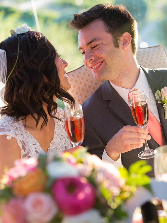 Bride and groom toasting at a vinery in Temecula